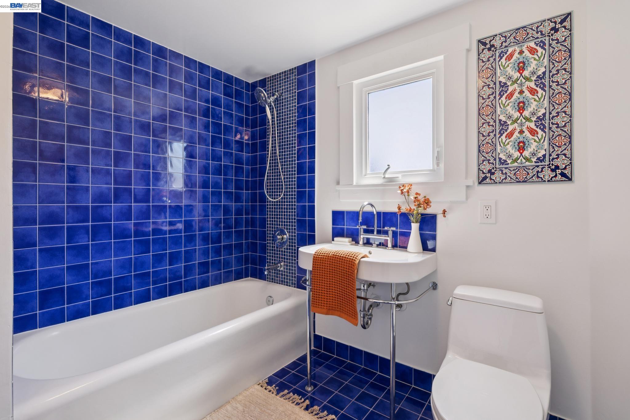 1635 High Street Alameda, CA 94501 - Photo 41 of 56 a bathroom with a toilet a sink and bathtub
