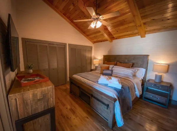 a bedroom with a bed and a flat screen tv