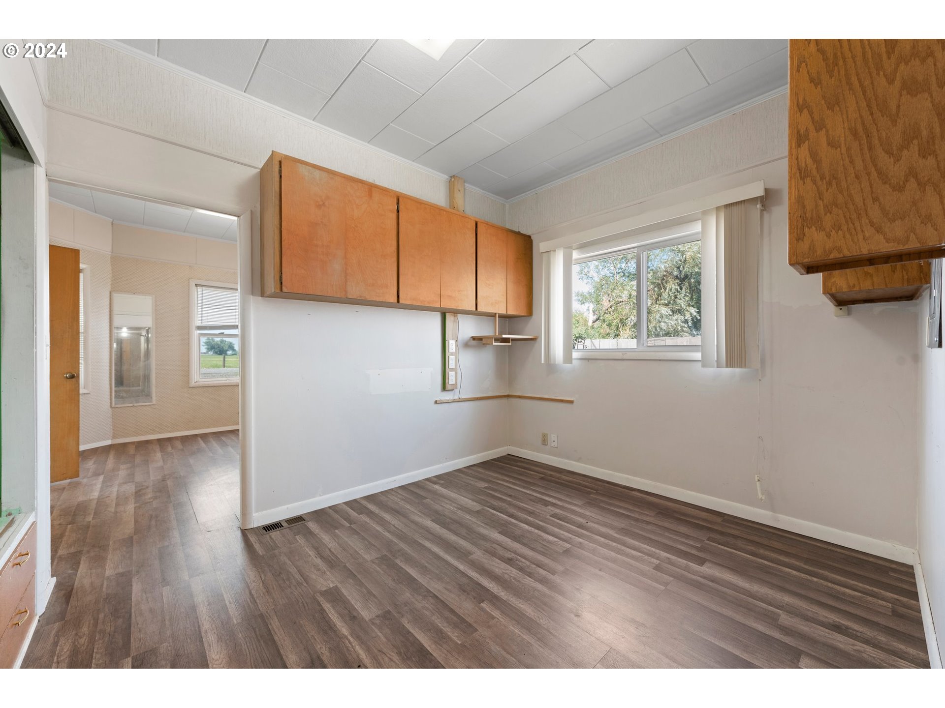42811 Hudson Road Baker City, OR 97814 - Photo 11 of 46 a view of an empty room with wooden floor and a window