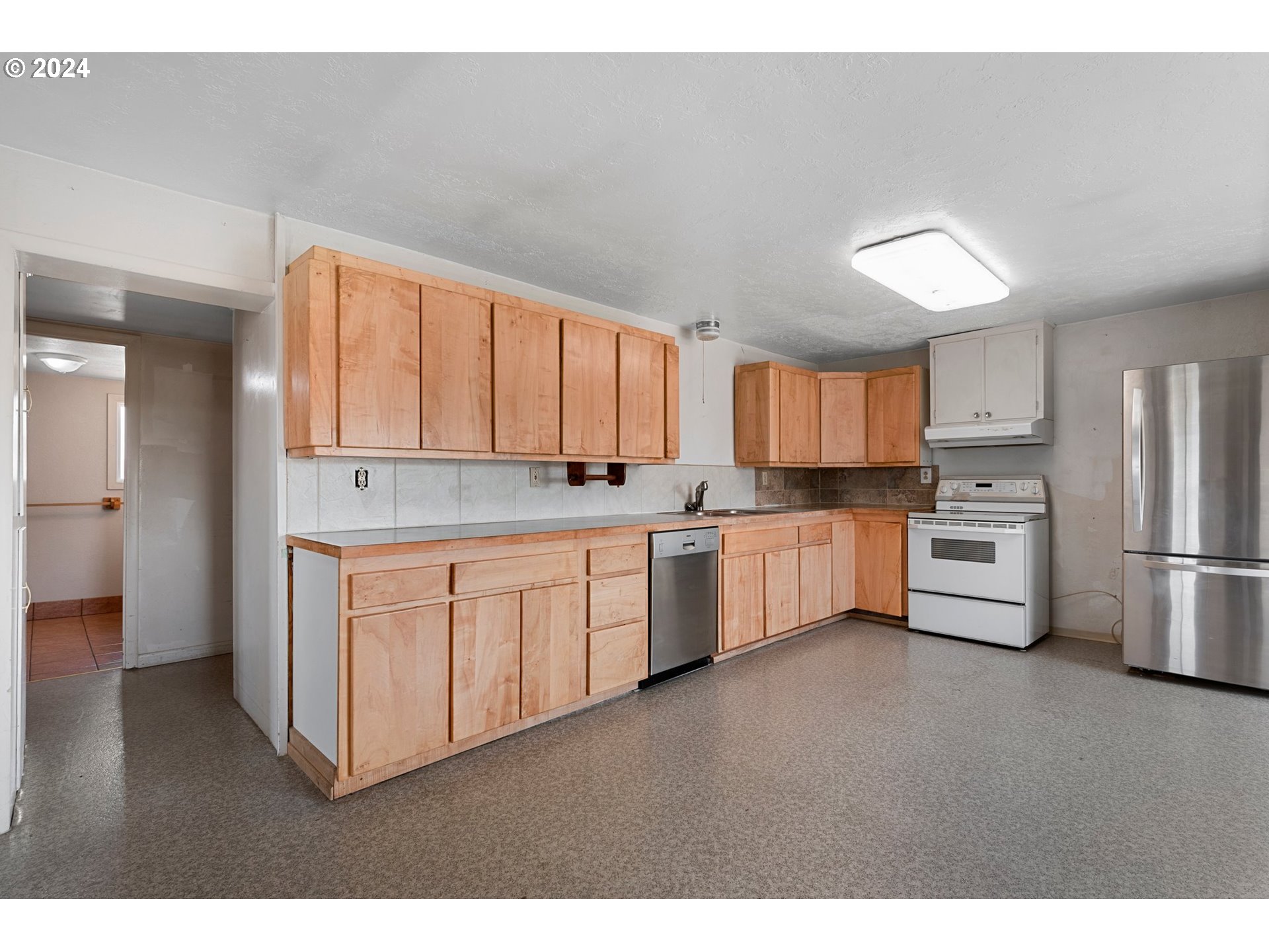 42811 Hudson Road Baker City, OR 97814 - Photo 17 of 46 a kitchen with stainless steel appliances granite countertop a refrigerator sink and cabinets