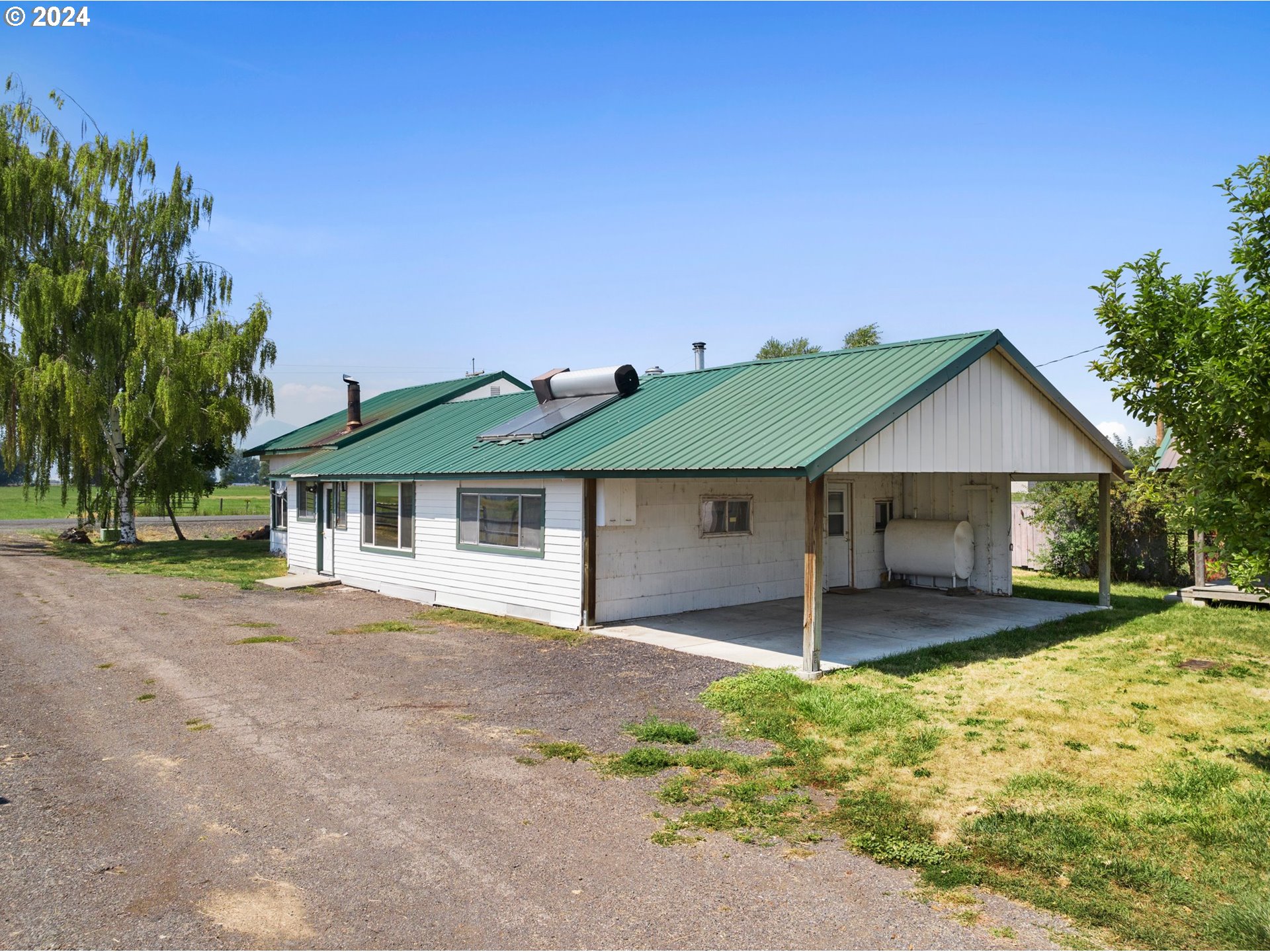 42811 Hudson Road Baker City, OR 97814 - Photo 28 of 46 a front view of a house with a garden and yard