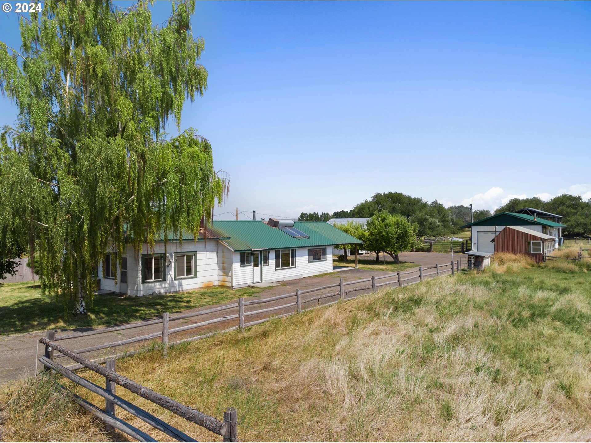 42811 Hudson Road Baker City, OR 97814 - Photo 5 of 46 a view of a house with pool lawn chairs and a yard