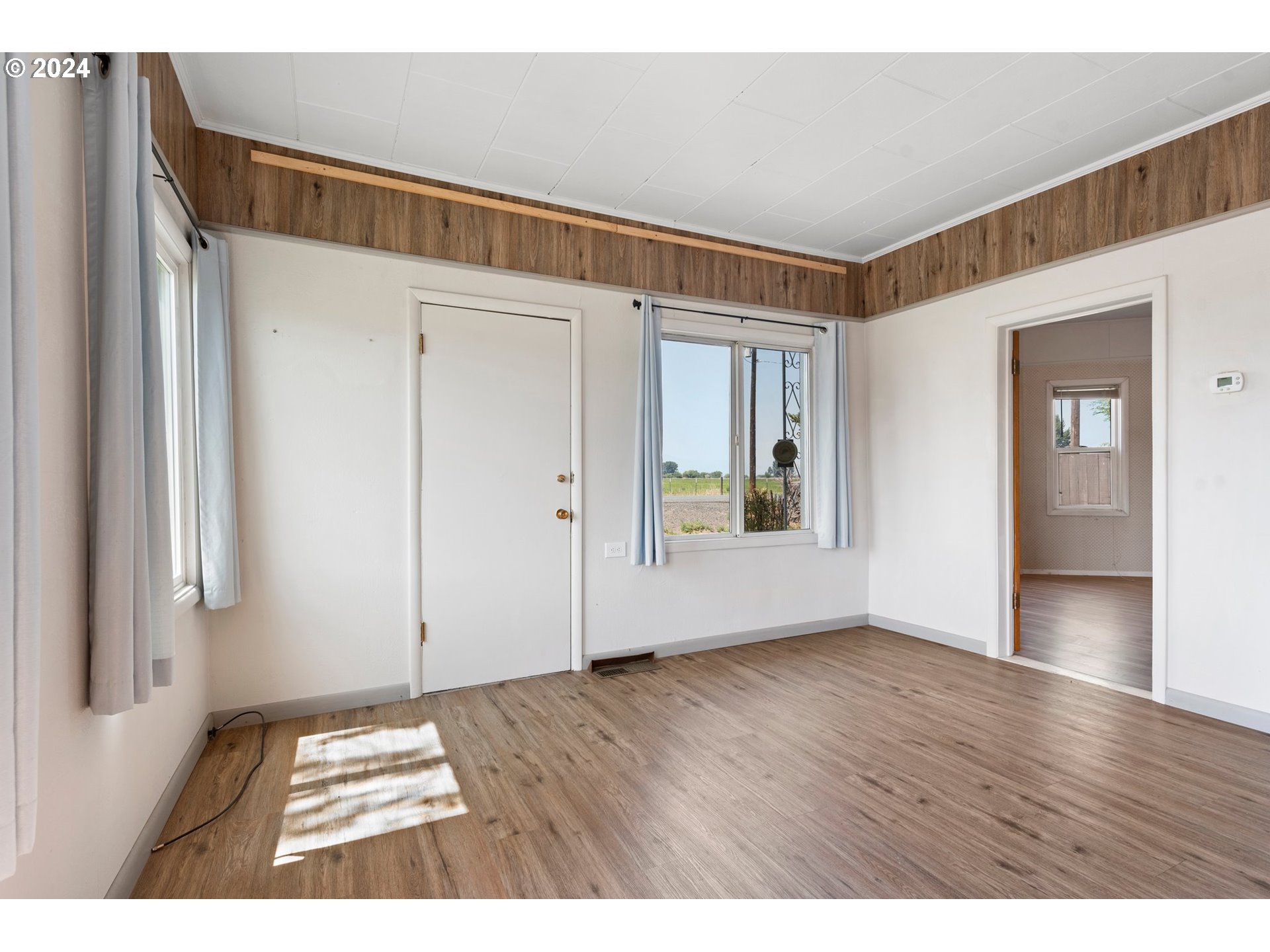 42811 Hudson Road Baker City, OR 97814 - Photo 8 of 46 a view of an empty room with wooden floor and a window
