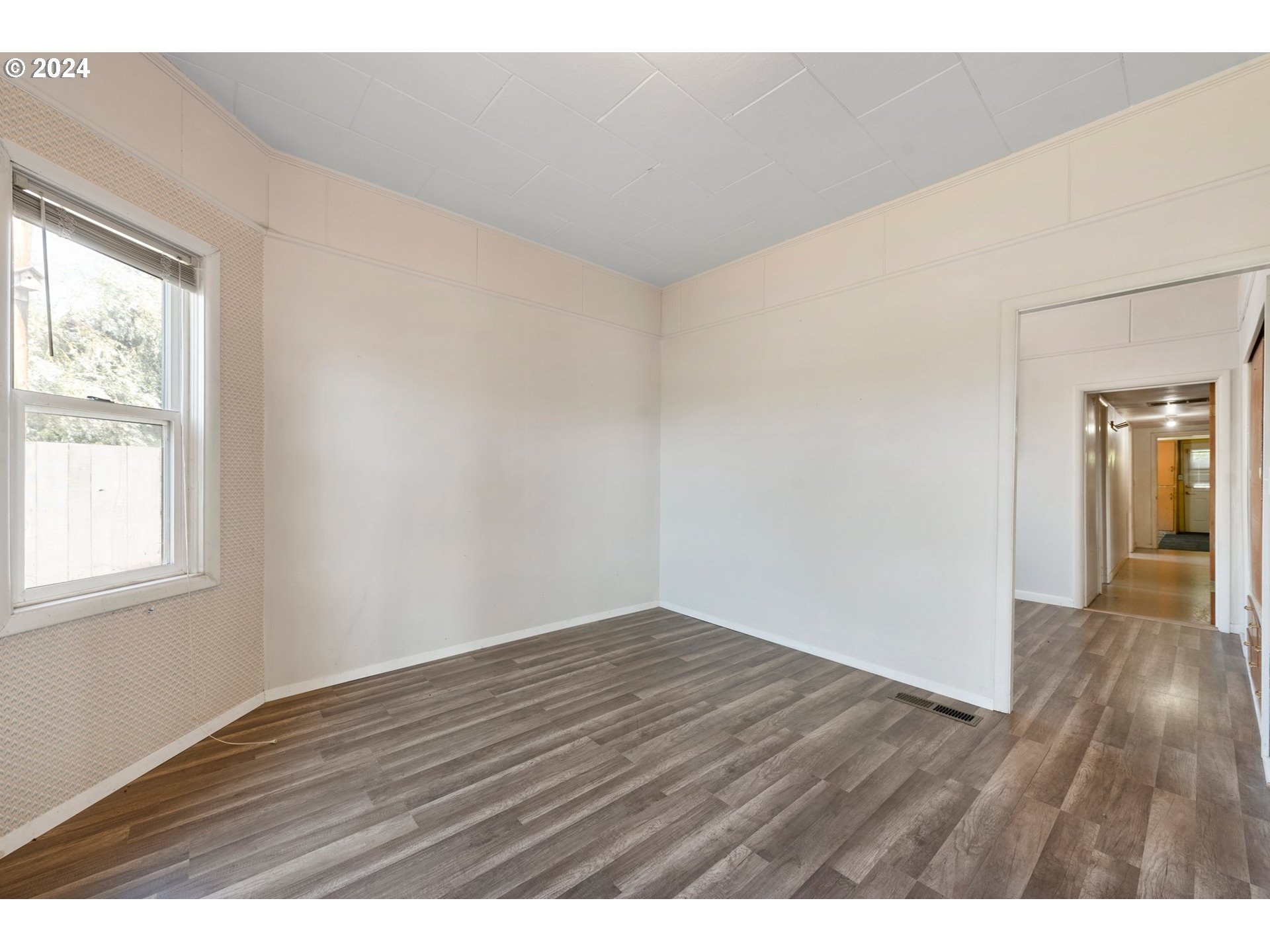 42811 Hudson Road Baker City, OR 97814 - Photo 10 of 46 a view of an empty room with wooden floor and a window