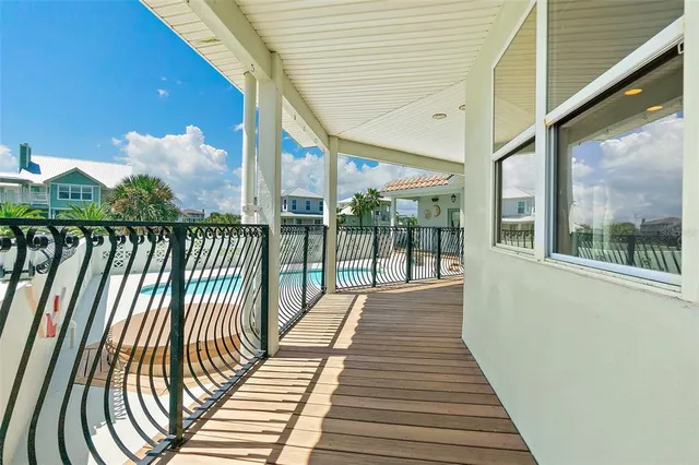 a view of a room with wooden floor and windows
