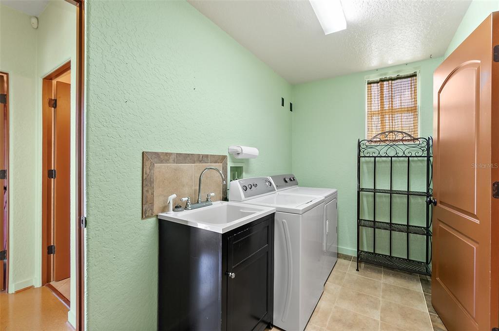54 Ocean Street Palm Coast, FL 32137 - Photo 22 of 90 a utility room with dryer and washer