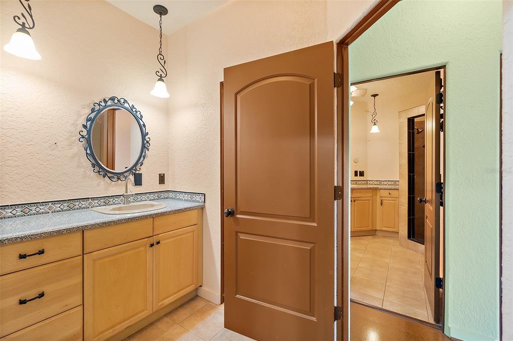 54 Ocean Street Palm Coast, FL 32137 - Photo 24 of 90 a bathroom with a granite countertop sink toilet and shower