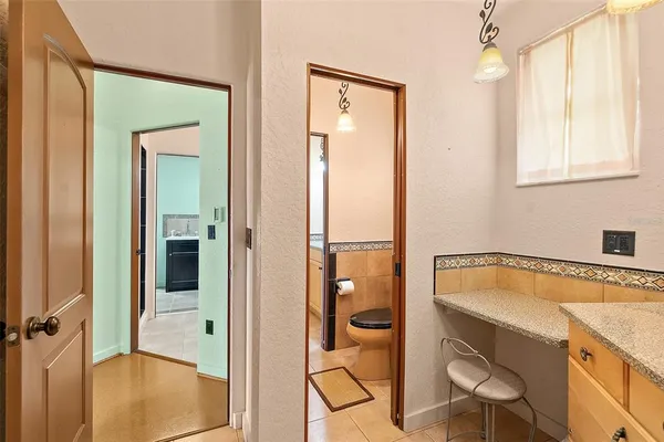 a view of a livingroom with furniture a ceiling fan and window