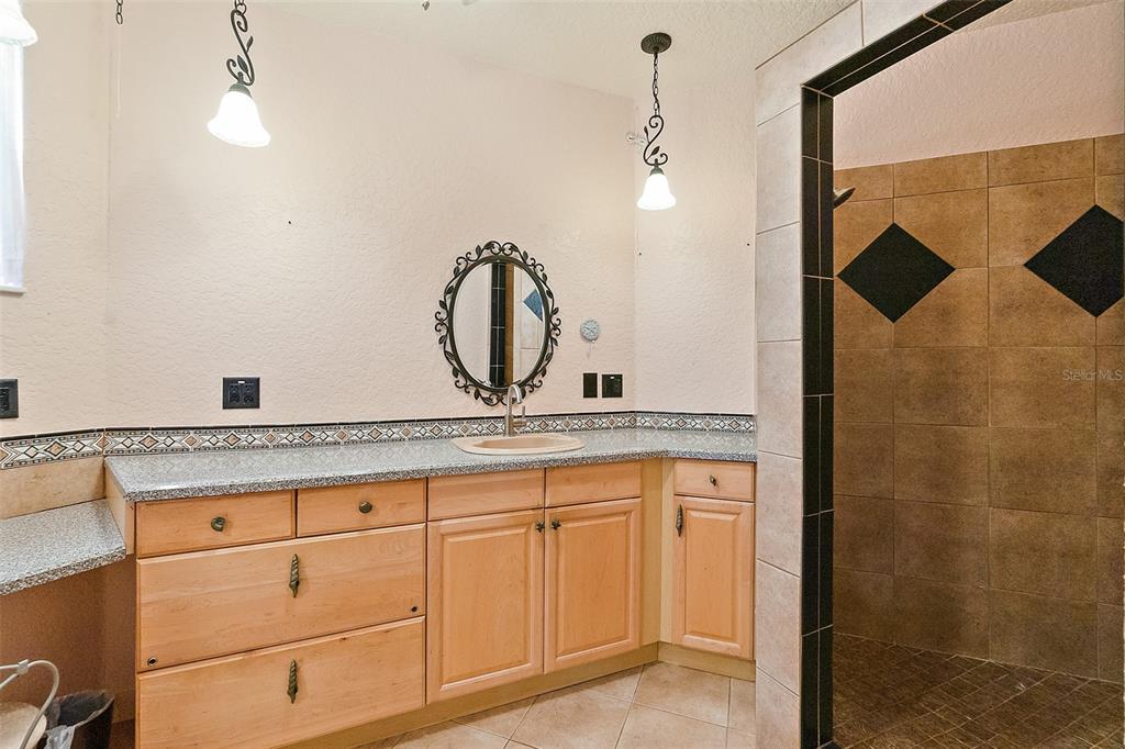 54 Ocean Street Palm Coast, FL 32137 - Photo 29 of 90 a bathroom with a granite countertop sink and a mirror