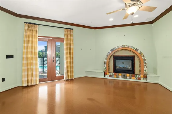 a view of an empty room with closet and wooden door