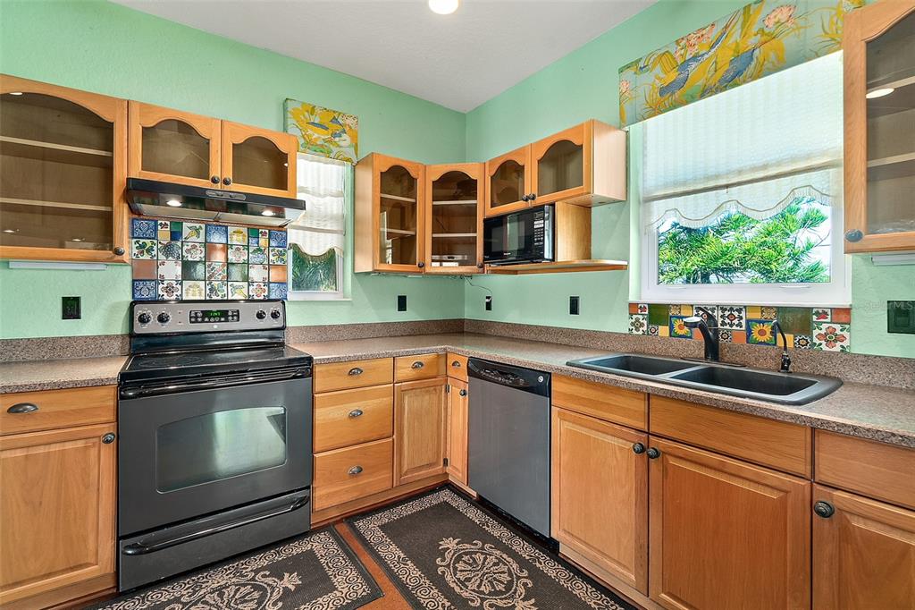 54 Ocean Street Palm Coast, FL 32137 - Photo 35 of 90 a kitchen with stainless steel appliances granite countertop a stove and a sink