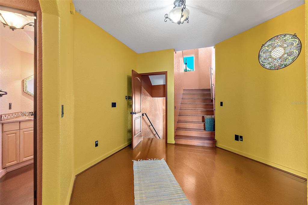54 Ocean Street Palm Coast, FL 32137 - Photo 52 of 90 a view of hallway with stairs and wooden floor