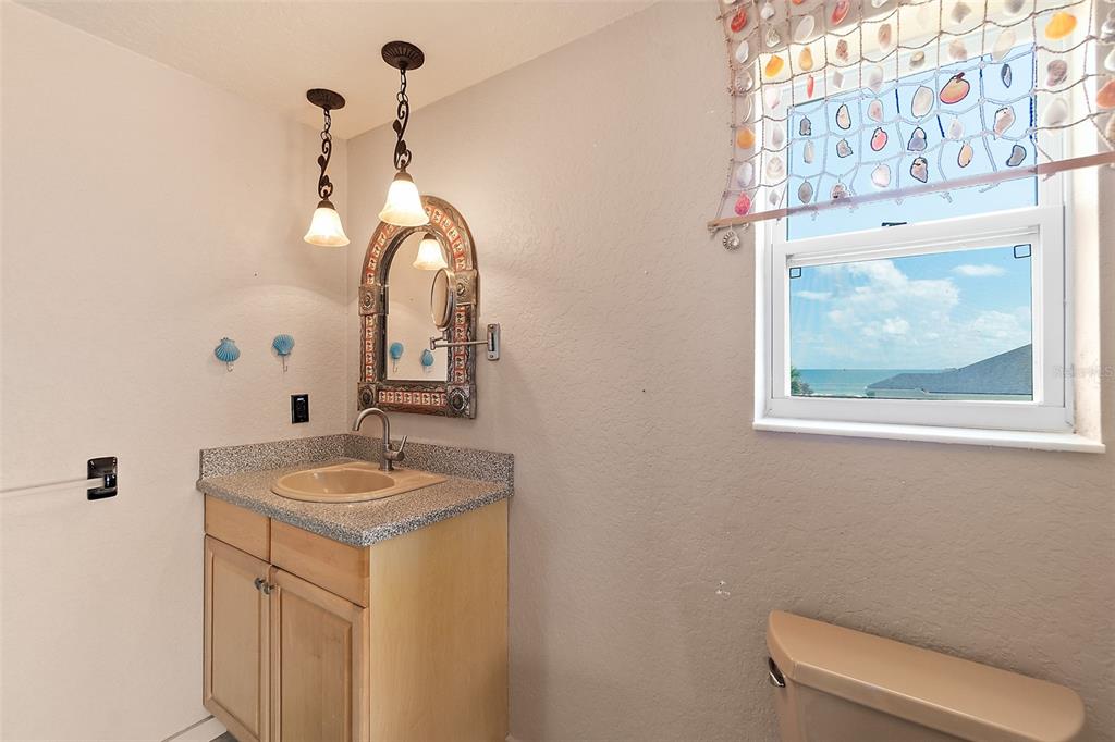 54 Ocean Street Palm Coast, FL 32137 - Photo 6 of 90 a bathroom with a granite countertop sink and a mirror