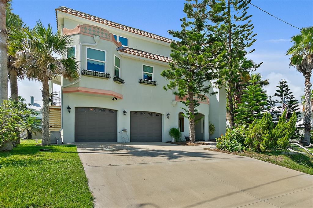 54 Ocean Street Palm Coast, FL 32137 - Photo 72 of 90 a front view of a house with a yard and garage