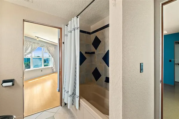 a view of a kitchen with stainless steel appliances granite countertop a refrigerator and a stove top oven