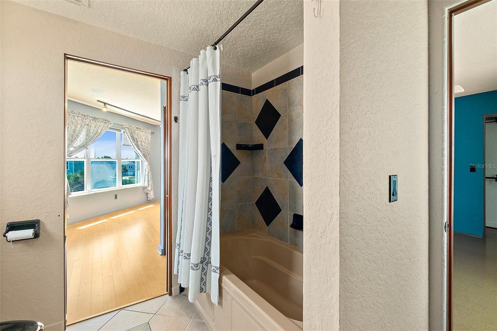 54 Ocean Street Palm Coast, FL 32137 - Photo 8 of 90 a bathroom with a glass shower door and a mirror