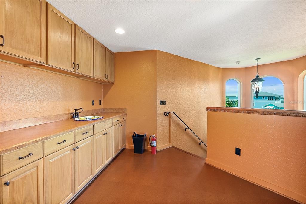 54 Ocean Street Palm Coast, FL 32137 - Photo 10 of 90 a kitchen with white cabinets and sink