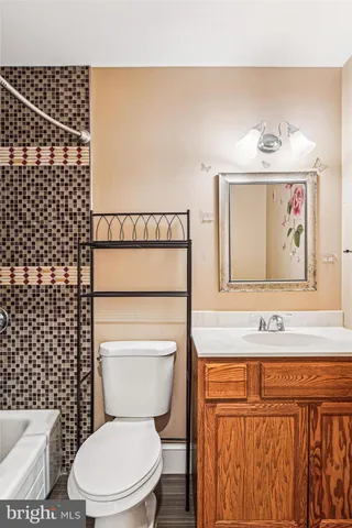 a large white kitchen with stainless steel appliances kitchen island granite countertop a refrigerator and a stove