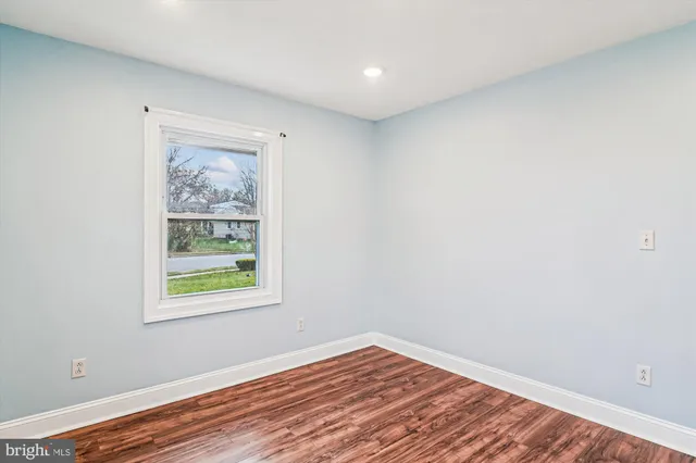 a view of a room with wooden floor and window