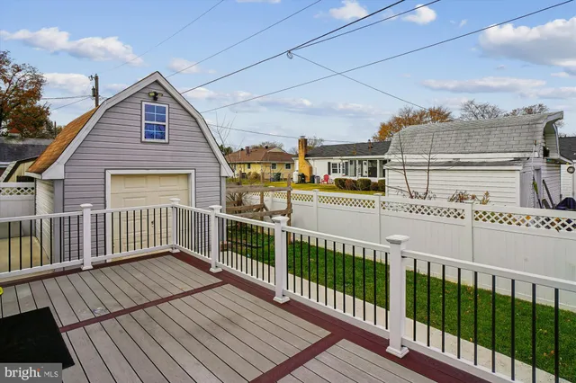 a view of an empty room with wooden floor and closet