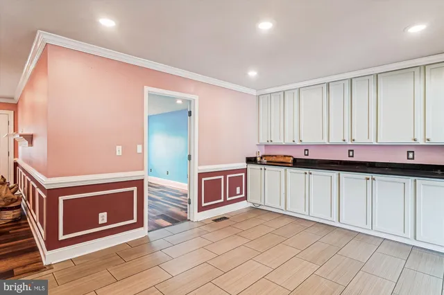 a kitchen with stainless steel appliances granite countertop a stove a sink and a refrigerator with wooden floor