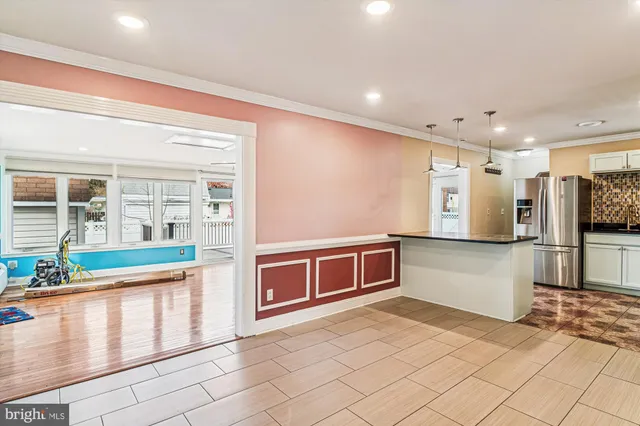 a view of a room with wooden floor and entryway