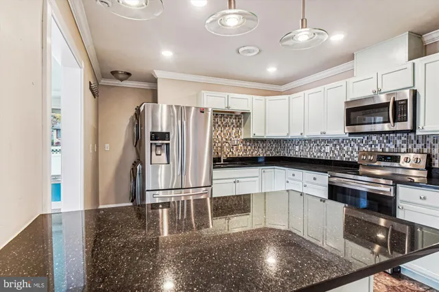 a view of a big room with wooden floor and windows