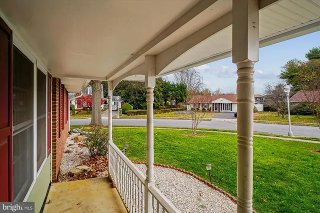 a front view of a house with a garden and yard