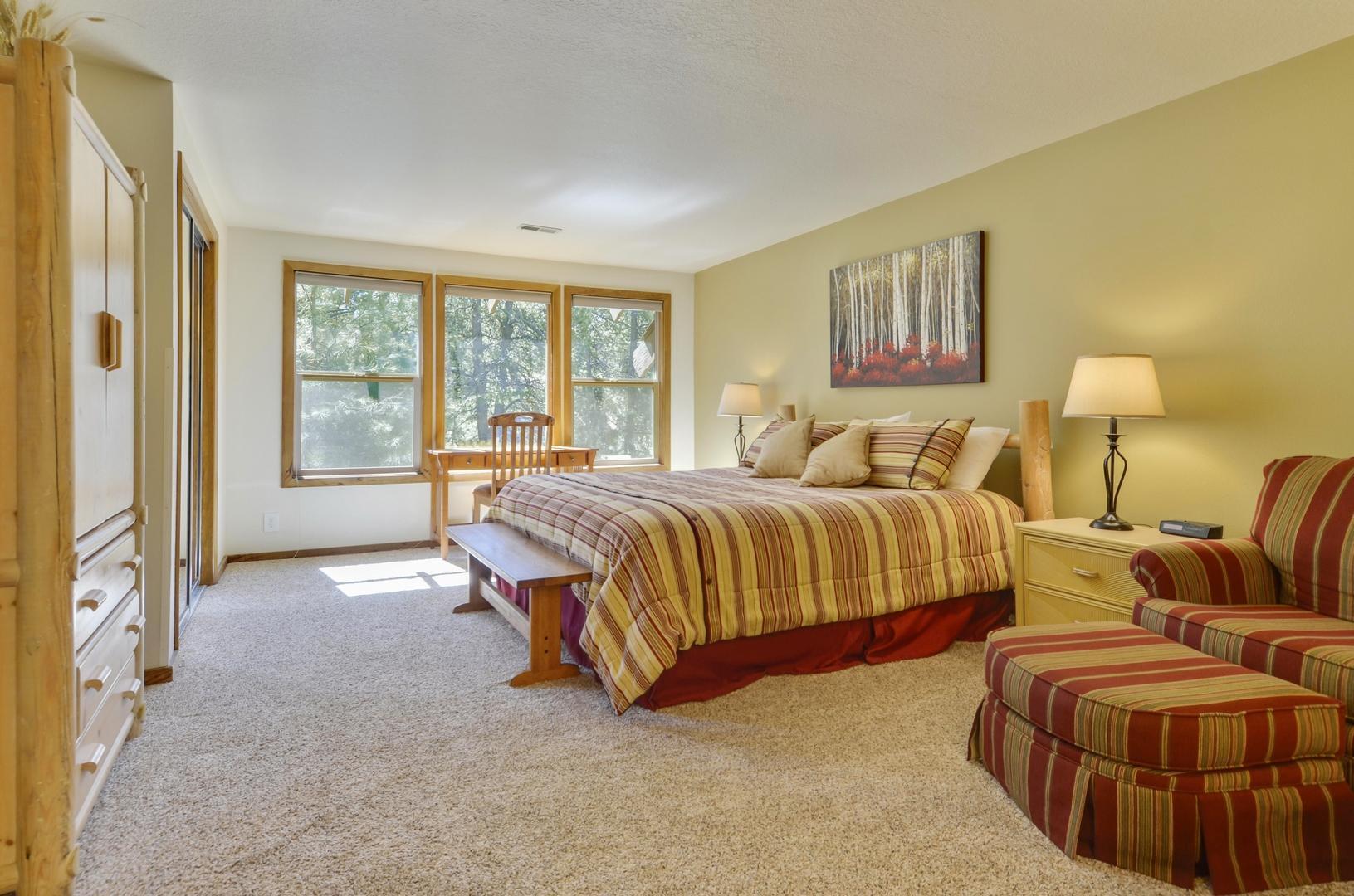 57301 Beaver Ridge Loop, Unit 10 Sunriver, OR 97707 - Photo 11 of 23 a spacious bedroom with a bed and glass window