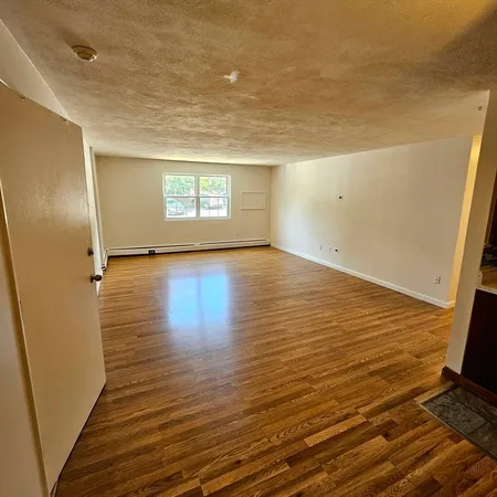 a view of an empty room and a window