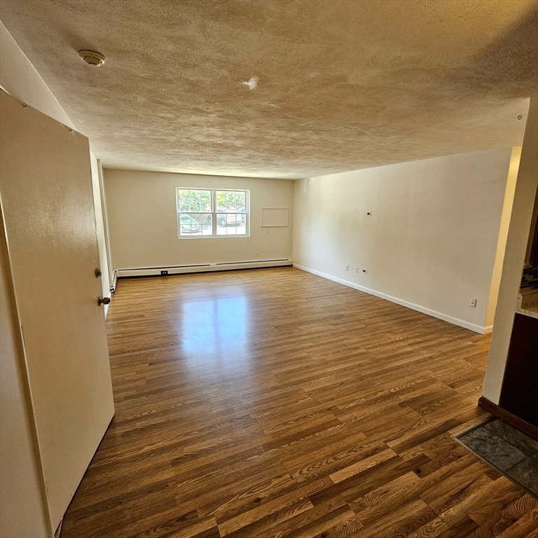 245 Boston Post Road East, Unit 7 Northborough, MA 01532 - Photo 3 of 10 a view of an empty room and a window