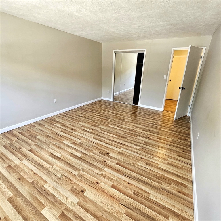 245 Boston Post Road East, Unit 7 Northborough, MA 01532 - Photo 5 of 10 a view of a big room with wooden floor