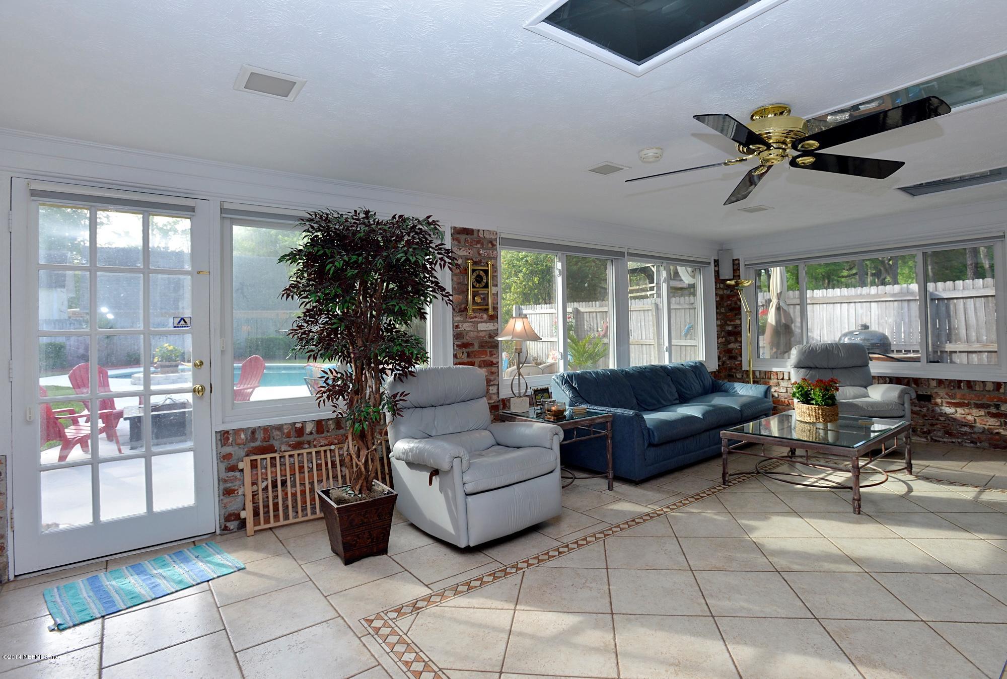 11330 Scott Mill Road Jacksonville, FL 32223 - Photo 20 of 28 a living room with furniture and a large window