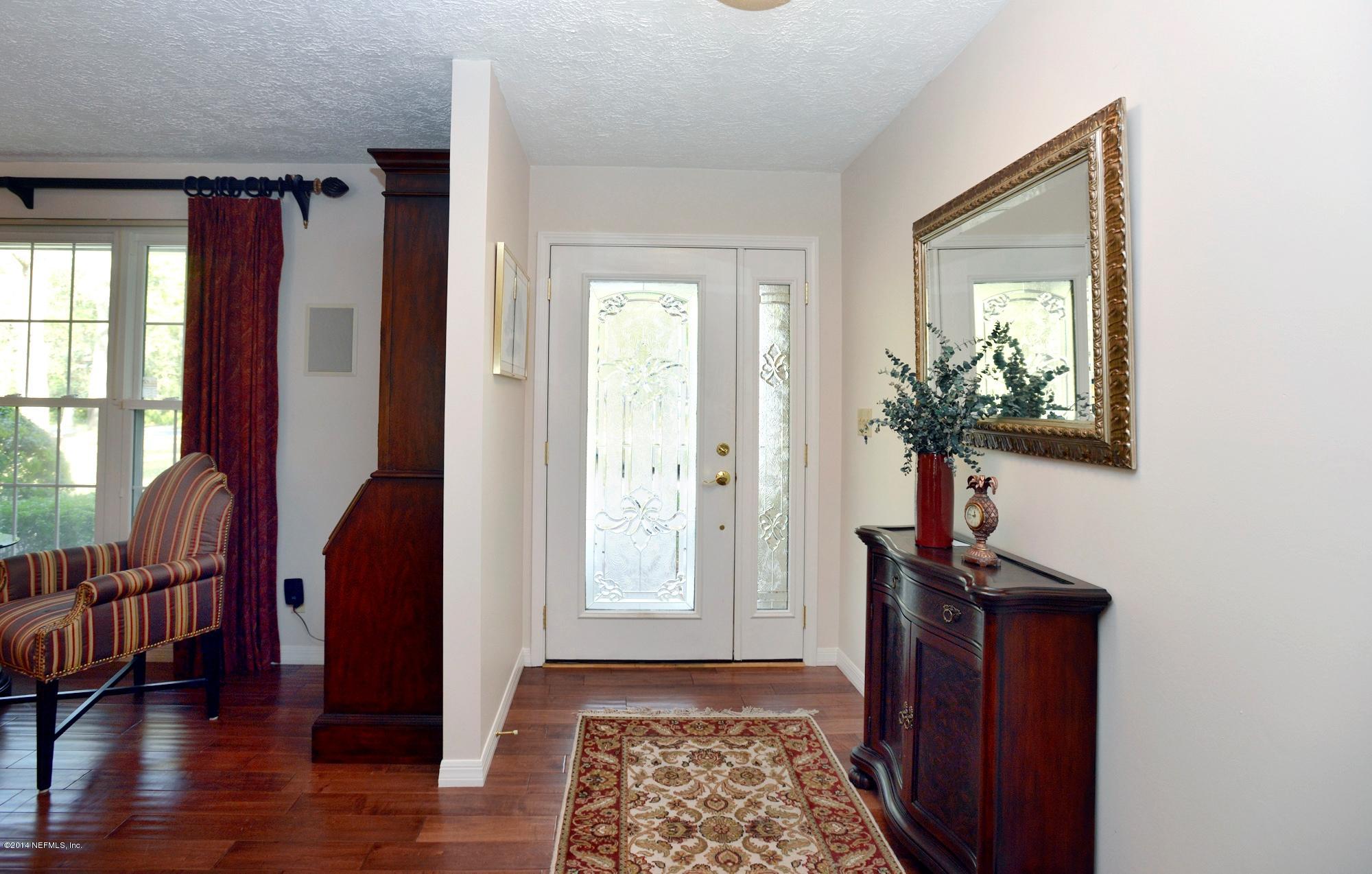 11330 Scott Mill Road Jacksonville, FL 32223 - Photo 7 of 28 a view of hallway with furniture and a window