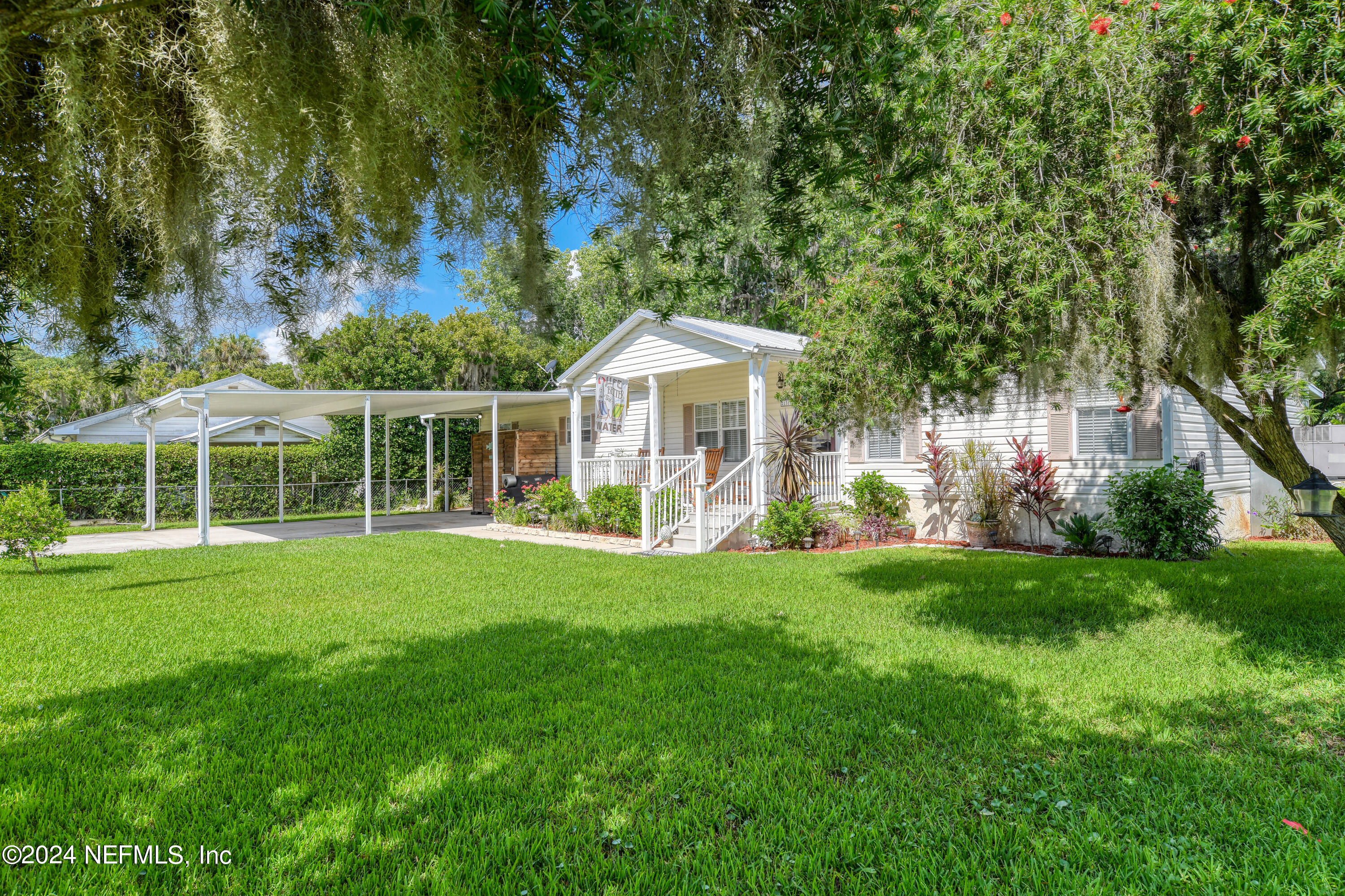 a front view of a house with a garden and porch