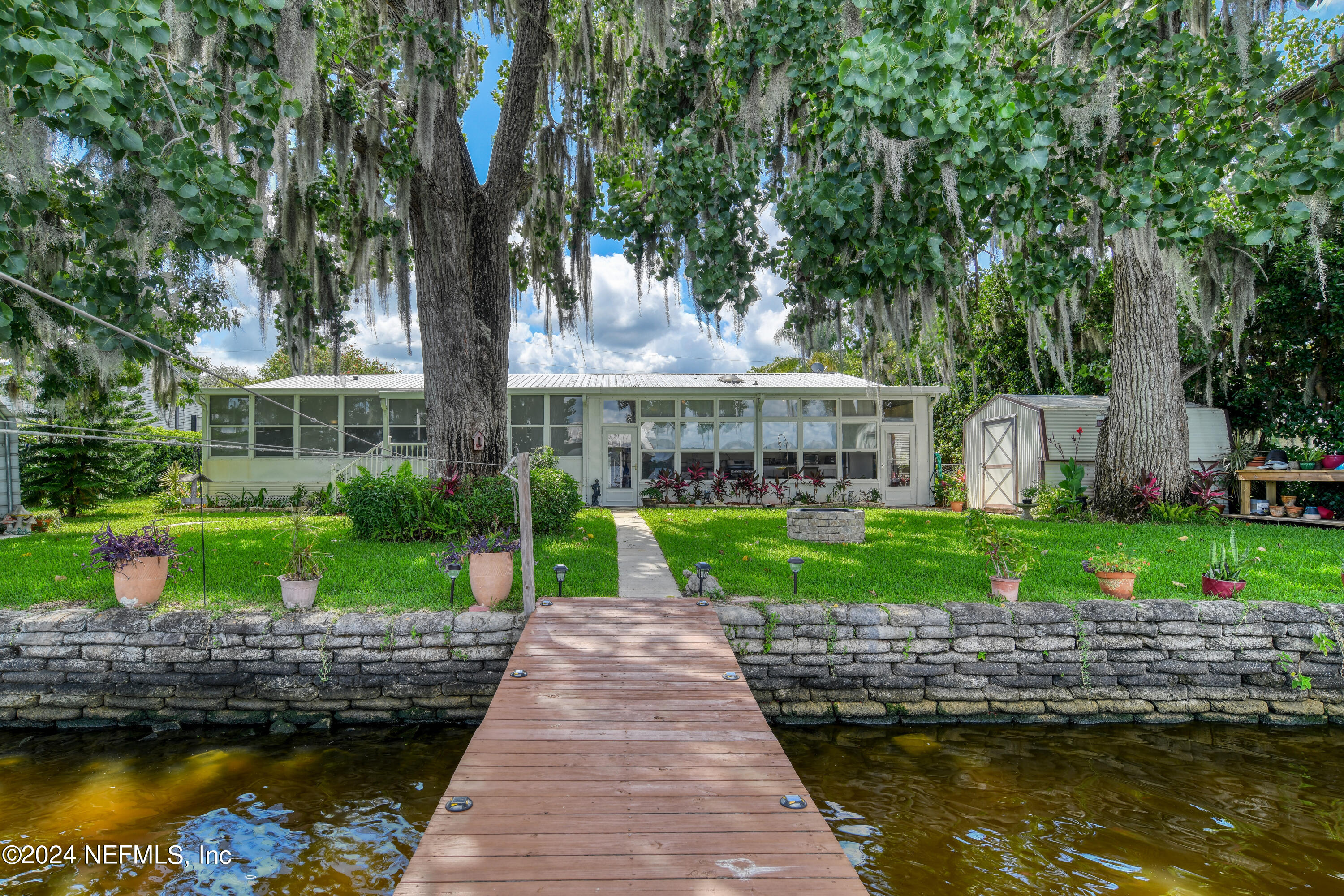 131 Sunset Drive Crescent City, FL 32112 - Photo 24 of 33 a view of house with swimming pool and outdoor seating