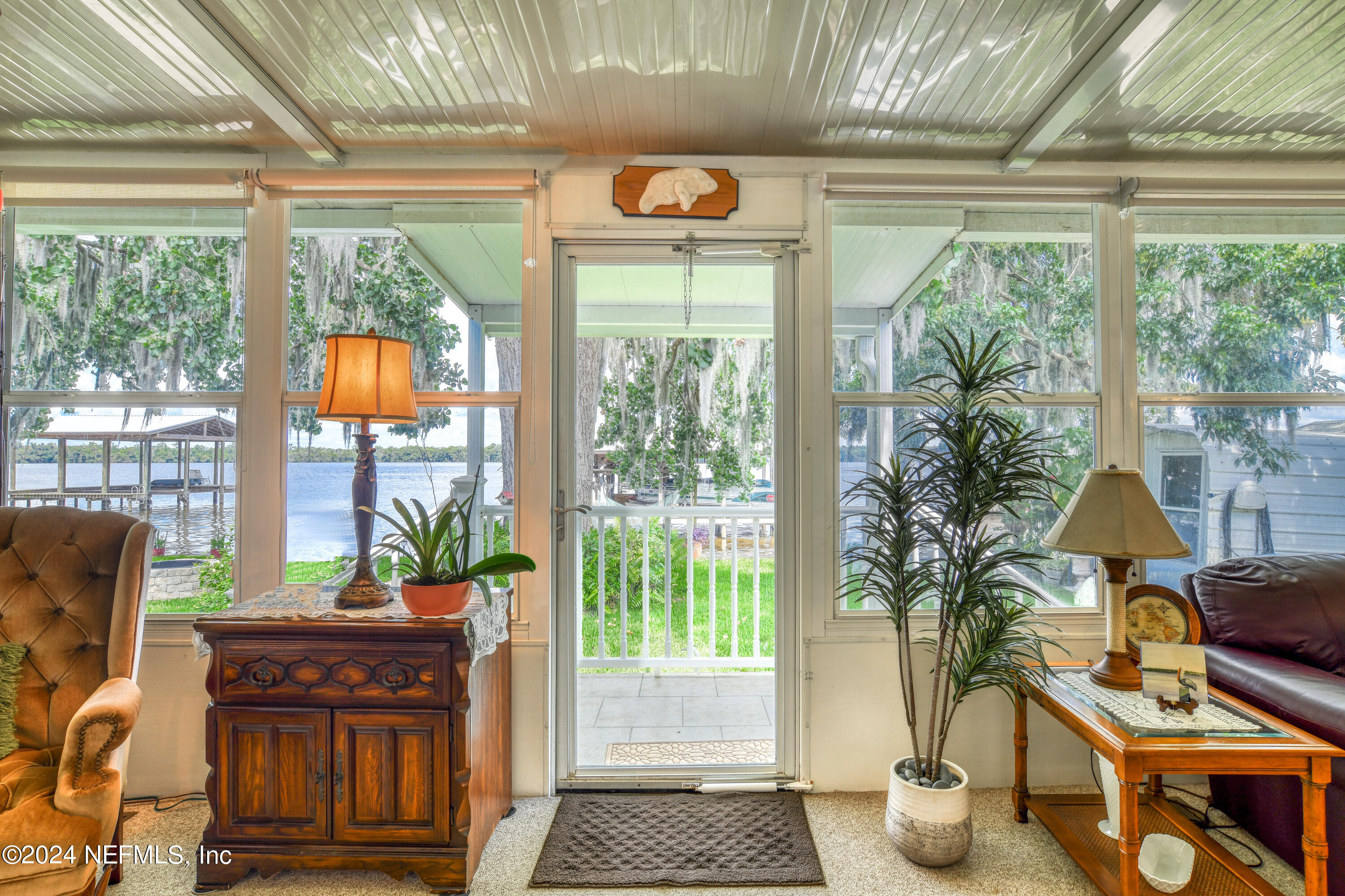 131 Sunset Drive Crescent City, FL 32112 - Photo 25 of 33 a living room with furniture a window and a chandelier
