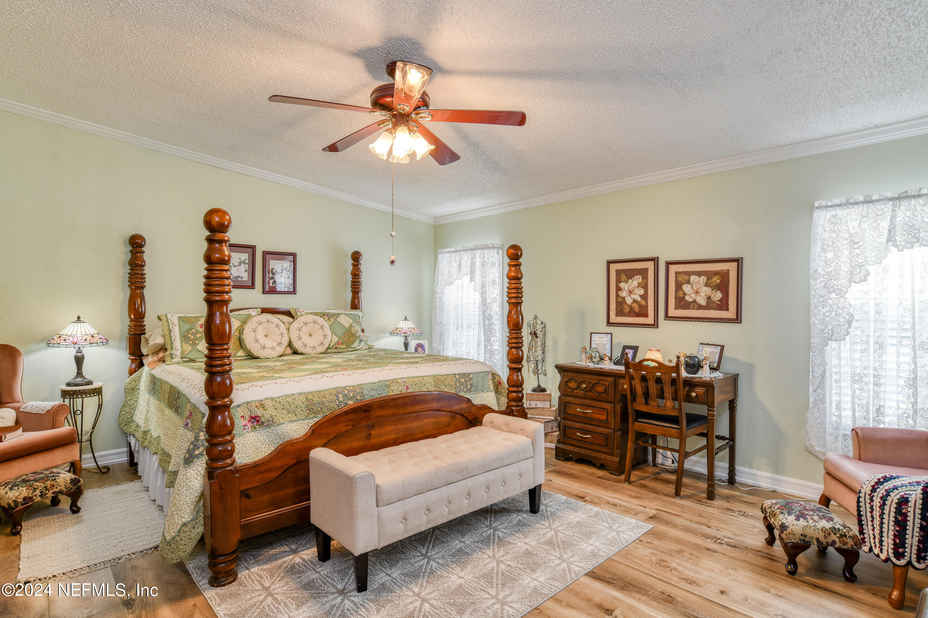 131 Sunset Drive Crescent City, FL 32112 - Photo 9 of 33 a spacious bedroom with a bed a couch and a chandelier