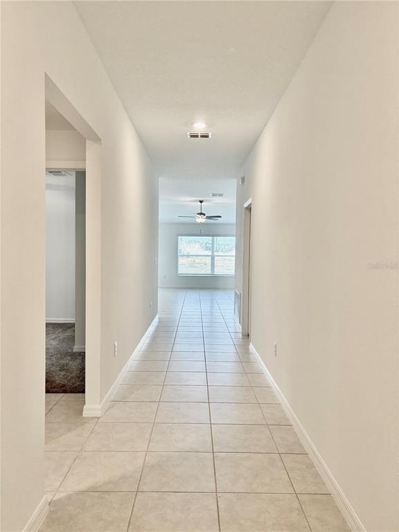 11237 Linden Depot Road San Antonio, FL 33576 - Photo 12 of 31 a view of a hallway with wooden floor and a bathroom