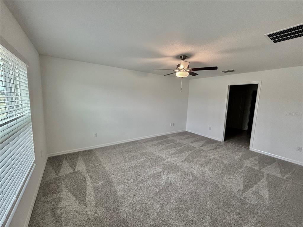 11237 Linden Depot Road San Antonio, FL 33576 - Photo 13 of 31 wooden floor in an empty room with a window