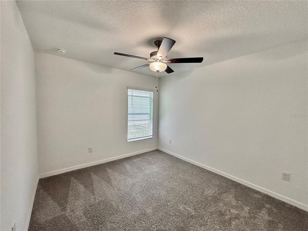 11237 Linden Depot Road San Antonio, FL 33576 - Photo 15 of 31 an empty room with windows and fan