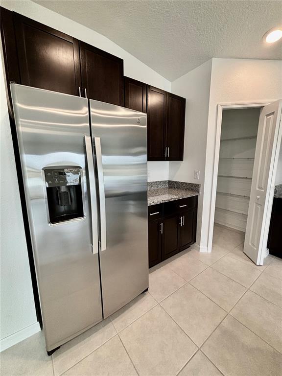 11237 Linden Depot Road San Antonio, FL 33576 - Photo 8 of 31 a kitchen with granite countertop a refrigerator and microwave