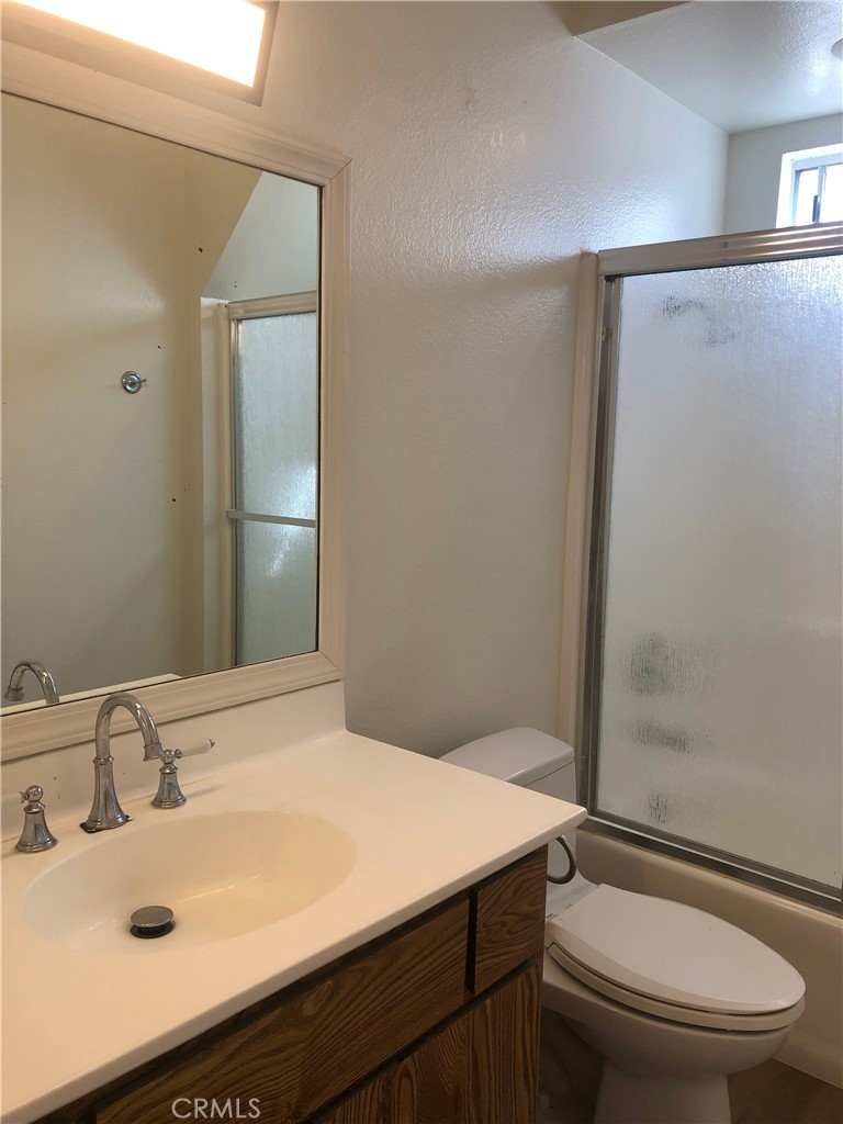 16621 Dolores Lane, Unit B Huntington Beach, CA 92649 - Photo 16 of 22 a bathroom with a sink toilet and shower