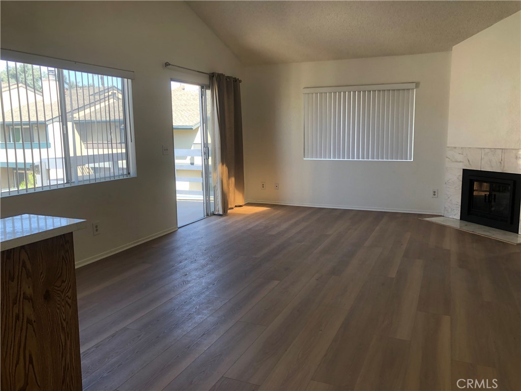 16621 Dolores Lane, Unit B Huntington Beach, CA 92649 - Photo 6 of 22 a view of an empty room with wooden floor and a window