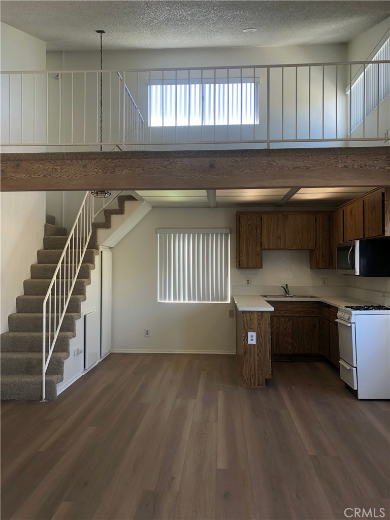 16621 Dolores Lane, Unit B Huntington Beach, CA 92649 - Photo 8 of 22 a kitchen with a window a sink and a counter top space