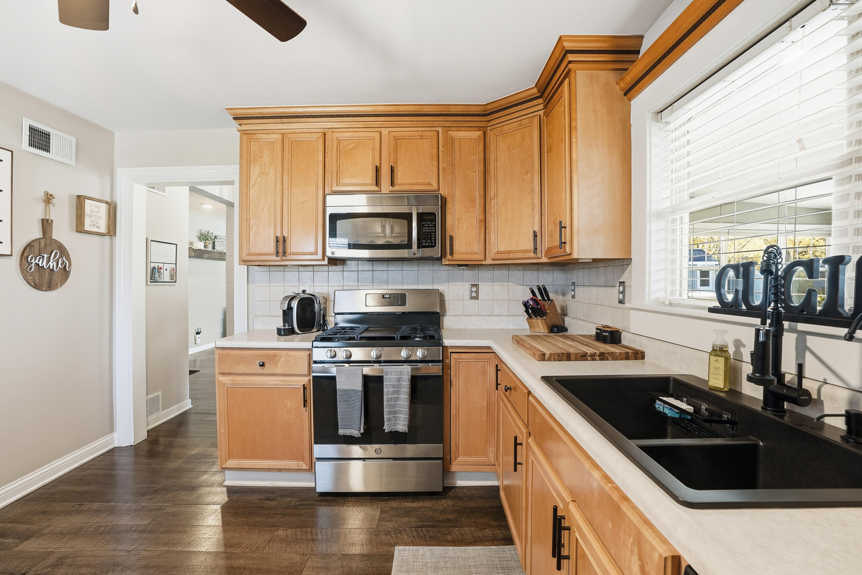 3725 West 105th Avenue Crown Point, IN 46307 - Photo 20 of 37 a kitchen with stainless steel appliances a stove a sink a microwave and cabinets