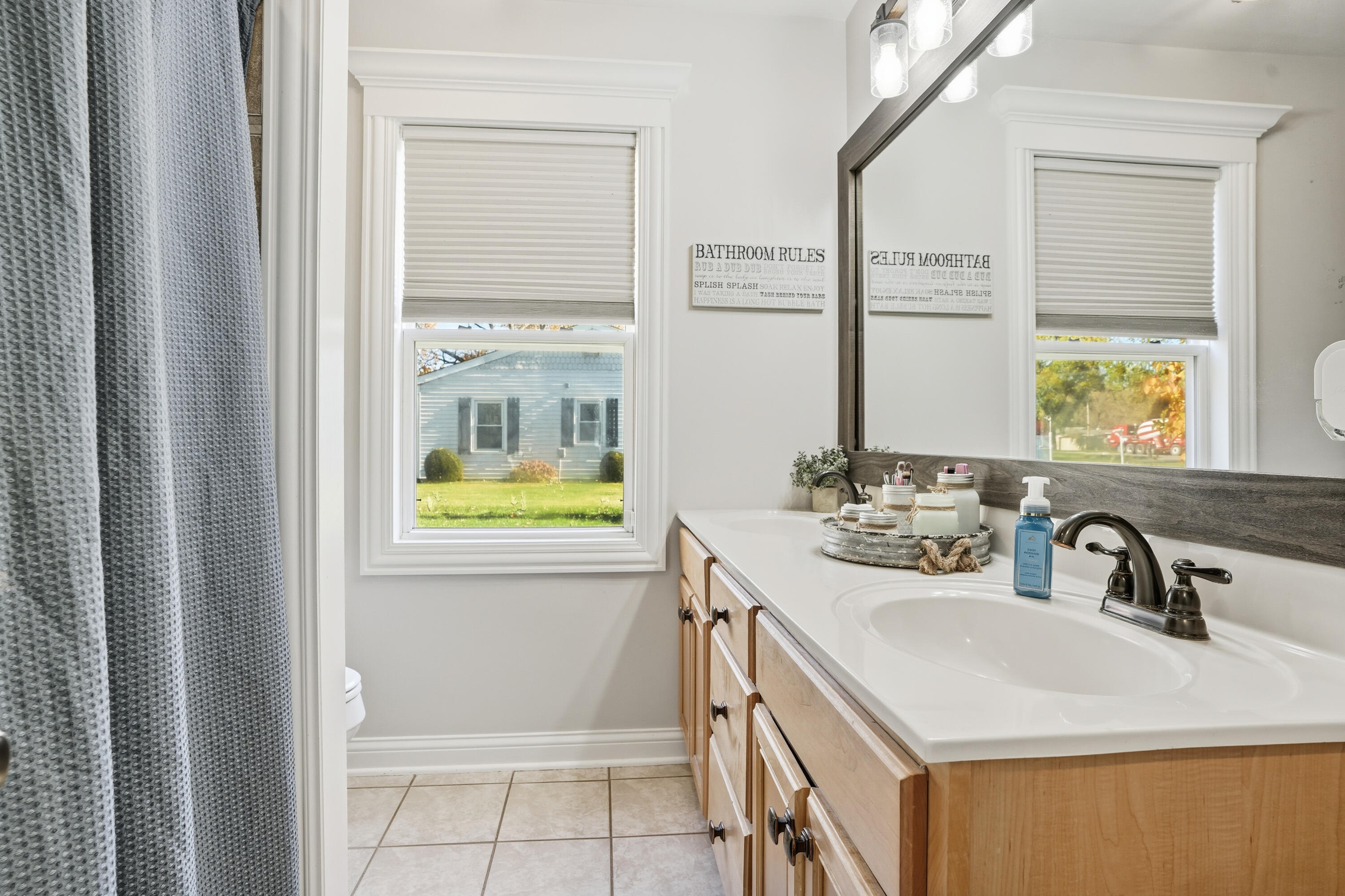 3725 West 105th Avenue Crown Point, IN 46307 - Photo 28 of 37 a bathroom with a sink a vanity and a mirror
