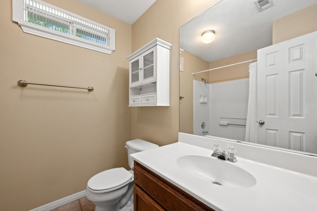 5208 Sioux Lane Austin, TX 78734 - Photo 19 of 35 A compact bathroom offers functionality with a vanity, toilet, and shower with a simple yet effective design.