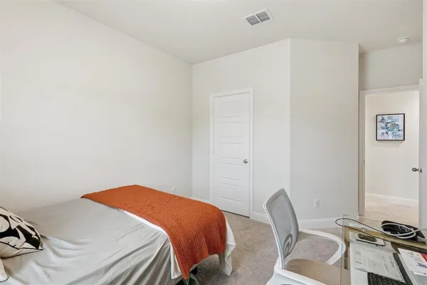 a bedroom with a bed and chair