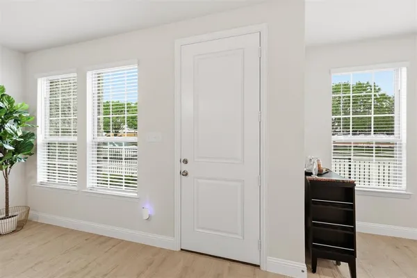 a view of a room with a window and wooden floor